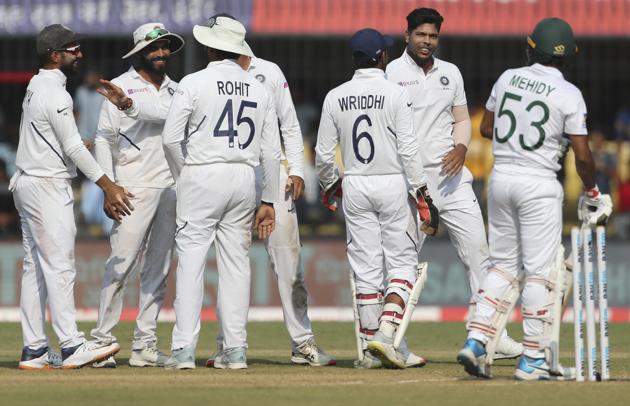 India's Umesh Yadav, second right, and teammates celebrate the dismissal of Bangladesh's Mehidy Hasan. (AP)