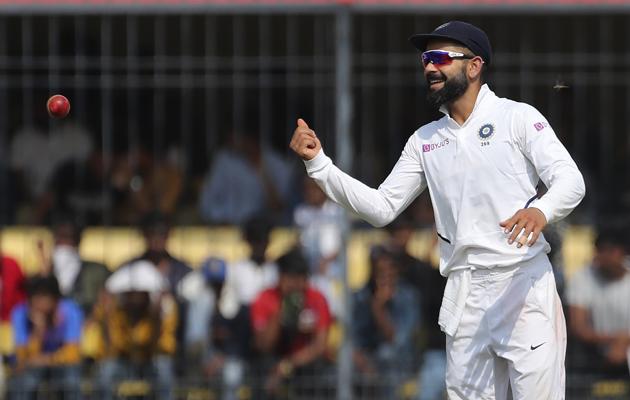 India's captain Virat Kohli smiles as he throws the ball towards a fielder. (AP)