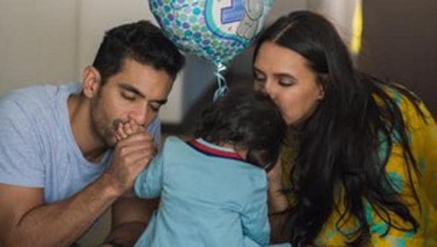 Neha Dhupia and Angad Bedi pose with Mehr.