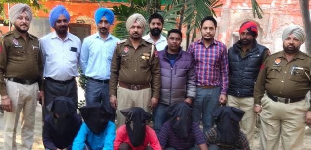 Members of the inter-state gang of robbers (with covered faces) in police custody in Patiala on Monday.(HT PHOTO)