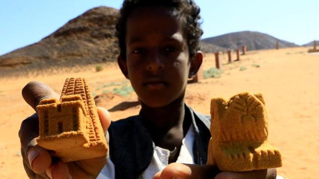 A tour vender displays miniature statues of lions and pyramids near the Royal Cemeteries of Meroe Pyramids. Sudan needs tourists after decades of isolation and hyperinflation. At Meroe, thanks to money from Qatar and German expertise, a visitor’s centre has been set up explaining the history of Sudan and the pyramids. There are walking tracks and a new reception centre. (Mohamed Nureldin Abdallah / REUTERS) A tour vender displays miniature statues of lions and pyramids near the Royal Cemeteries of Meroe Pyramids. Sudan needs tourists after decades of isolation and hyperinflation. At Meroe, thanks to money from Qatar and German expertise, a visitor’s centre has been set up explaining the history of Sudan and the pyramids. There are walking tracks and a new reception centre. (Mohamed Nureldin Abdallah / REUTERS)