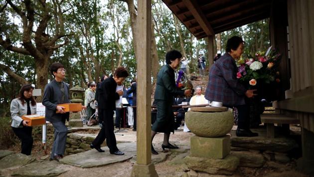 Participants offer prayers at Karematsu Shrine during an ecumenical service. When Japan’s ban on Christianity was lifted in 1873, some Hidden Christians joined the Catholic Church; others opted to maintain what they saw as the true faith of their ancestors. “They didn’t want to destroy the faith they had preserved all along despite suppression,” said Shigenori Murakami, the seventh-generation head of a group of Hidden Christians. (Issei Kato / REUTERS) Participants offer prayers at Karematsu Shrine during an ecumenical service. When Japan’s ban on Christianity was lifted in 1873, some Hidden Christians joined the Catholic Church; others opted to maintain what they saw as the true faith of their ancestors. “They didn’t want to destroy the faith they had preserved all along despite suppression,” said Shigenori Murakami, the seventh-generation head of a group of Hidden Christians. (Issei Kato / REUTERS)