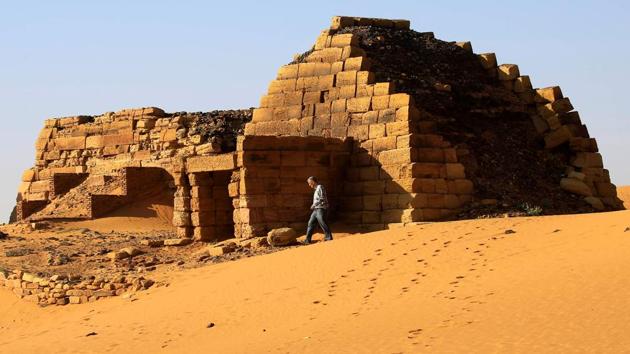 A tourist walks near the Royal Cemeteries of Meroe Pyramids. The new government has already started relaxing the visa system, including dropping a permit required for travel outside Khartoum, said Graham Abdel-Qadir, undersecretary of the ministry of information, culture and tourism. “There has been already a rise of tourists in October and November thanks to the new system,” he said. Arrivals fell this year because of unrest but numbers are expected to exceed 900,000 next year and might reach up to 1.2 million in 2021, he added. (Mohamed Nureldin Abdallah / REUTERS) A tourist walks near the Royal Cemeteries of Meroe Pyramids. The new government has already started relaxing the visa system, including dropping a permit required for travel outside Khartoum, said Graham Abdel-Qadir, undersecretary of the ministry of information, culture and tourism. “There has been already a rise of tourists in October and November thanks to the new system,” he said. Arrivals fell this year because of unrest but numbers are expected to exceed 900,000 next year and might reach up to 1.2 million in 2021, he added. (Mohamed Nureldin Abdallah / REUTERS)