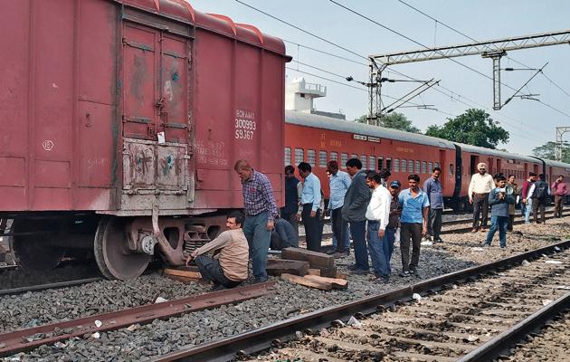 Railway officials inspecting the derailed wagon of the goods train near Domoria Bridge in Ludhiana on Tuesday; and (right) the sleepers which were damaged due to the derailment.(HT PHOTO) Railway officials inspecting the derailed wagon of the goods train near Domoria Bridge in Ludhiana on Tuesday; and (right) the sleepers which were damaged due to the derailment.(HT PHOTO)
