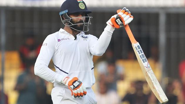 India's Ravindra Jadeja swings his bat to celebrate scoring fifty(AP)