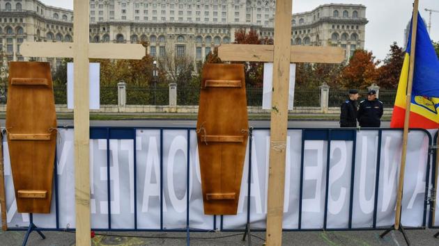 Wooden crosses in tribute of the "forest rangers heroes" honouring the killed forest guards in front of the Romanian Parliament during a protest in Bucharest. The latest tragedies have brought thousands of Romanians, including hundreds of rangers, into the streets to demand the government does more to protect the forests and their guardians. (Daniel MIHAILESCU / AFP) 