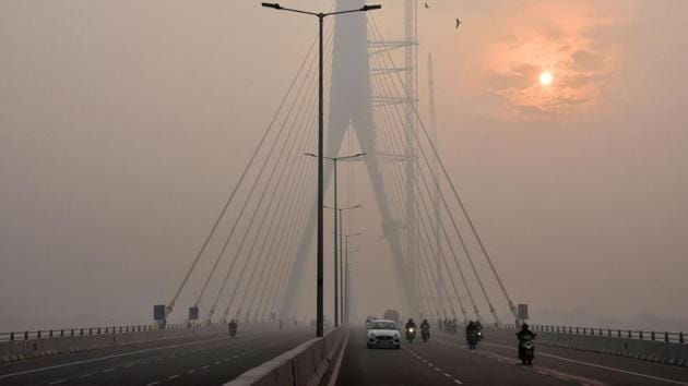 The sun is vaguely seen behind the Signature Bridge amid heavy smog, in New Delhi. The Narendra Modi government deployed 300 field teams to curb pollution after it reached record levels earlier this month, as winds carried smoke from farm stubble burning in areas around New Delhi.(PTI FILE) The sun is vaguely seen behind the Signature Bridge amid heavy smog, in New Delhi. The Narendra Modi government deployed 300 field teams to curb pollution after it reached record levels earlier this month, as winds carried smoke from farm stubble burning in areas around New Delhi.(PTI FILE)