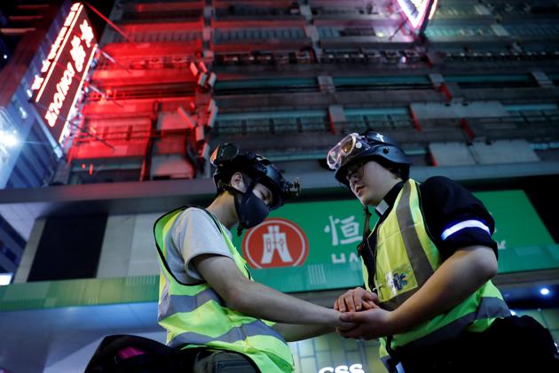 Pastor Alan Keung prays with a volunteer. Protesters are angry about what they see as police brutality and meddling by Beijing in the freedoms guaranteed under the “one country, two systems” formula adopted when the former British colony returned to Chinese rule in 1997. (Kim Kyung-Hoon / REUTERS)