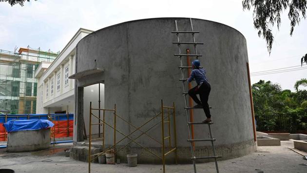 A worker climbs on the concrete entrance of the El Deposito. The reservoir fell into neglect after the war, turning into a dumpsite and even being invaded by squatters over the next half century. In 1973 the government declared the site a national shrine, and in 2016 a four-year cleanup started. (Ted ALJIBE / AFP)
