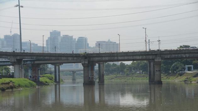 A view of Marikina river, which supplied water to the El Deposito. Construction crews have been working to finish a metal walkway and other infrastructure that will welcome visitors when the site is due to open to the public in February. (Ted ALJIBE / AFP)