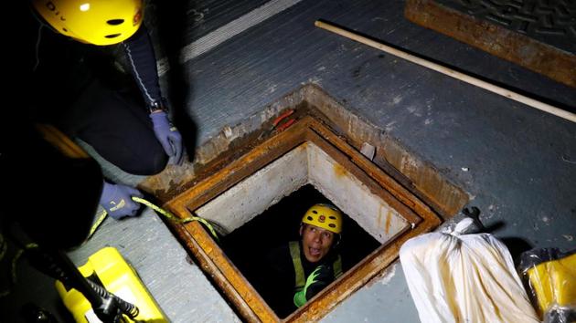 A rescue diver enters the sewer to search for anti-government protesters. Michelle, a 20-year-old student, said on the Polytechnic University’s Kowloon peninsula campus. More than 1,000 protesters who tried to leave earlier this week were arrested, and most of those who remain say they hope to avoid being arrested for rioting or on other charges. (Thomas Peter / REUTERS)