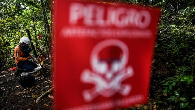 An ex-combatant of the FARC-EP takes part in a humanitarian de-mining training in the municipality of La Montanita, Caqueta. A grenade blew off the hands of onetime guerrilla Edwin Correa, but he only surrendered his rifle once a peace deal was struck nearly three years ago. Since then, the former bomb expert has joined a different sort of fighting unit, one dedicated to removing the land mines in Colombia’s countryside that he once helped to plant. (Juan Barreto / AFP) An ex-combatant of the FARC-EP takes part in a humanitarian de-mining training in the municipality of La Montanita, Caqueta. A grenade blew off the hands of onetime guerrilla Edwin Correa, but he only surrendered his rifle once a peace deal was struck nearly three years ago. Since then, the former bomb expert has joined a different sort of fighting unit, one dedicated to removing the land mines in Colombia’s countryside that he once helped to plant. (Juan Barreto / AFP)