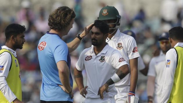 Bangladesh's team physio talks with Liton Das after he was injured by a delivery.(AP)