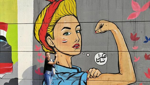 A woman poses for a photo in front of graffiti at the Saadoun tunnel. “We want a nation, not a prison,” says one painting that depicts a man bursting free from behind bars. “Plant a revolution, and you will harvest a nation,” reads another showing a hand flashing the victory sign over protesters heads. Some of the messages are less sentimental. “Look at us, Americans, this is all your fault,” declares one. (Khalid Mohammed / AP) A woman poses for a photo in front of graffiti at the Saadoun tunnel. “We want a nation, not a prison,” says one painting that depicts a man bursting free from behind bars. “Plant a revolution, and you will harvest a nation,” reads another showing a hand flashing the victory sign over protesters heads. Some of the messages are less sentimental. “Look at us, Americans, this is all your fault,” declares one. (Khalid Mohammed / AP)