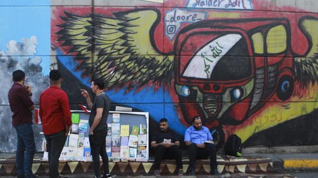 Many of the murals carry calls for anti-sectarianism, peace and a free Iraq. In one painting, a little girl cries, declaring “They killed my dream,” referring to the group of men behind her, some in religious clothes. Another shows an Iraqi protester wearing a helmet against tear gas with the Arabic words: “In the heart is something that cannot be killed by guns, which is the nation.” Nearby is scrawled, in English, “All What I want is life.” (Hadi Mizban / AP) Many of the murals carry calls for anti-sectarianism, peace and a free Iraq. In one painting, a little girl cries, declaring “They killed my dream,” referring to the group of men behind her, some in religious clothes. Another shows an Iraqi protester wearing a helmet against tear gas with the Arabic words: “In the heart is something that cannot be killed by guns, which is the nation.” Nearby is scrawled, in English, “All What I want is life.” (Hadi Mizban / AP)