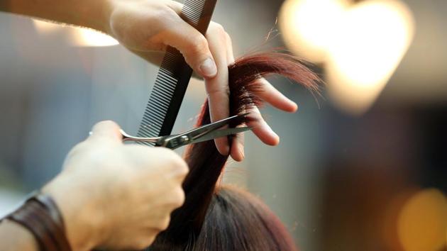 Hairdresser trimming blond hair with scissors (PICTURE FOR REPRESENTATIONAL PURPOSES ONLY) Hairdresser trimming blond hair with scissors (PICTURE FOR REPRESENTATIONAL PURPOSES ONLY)