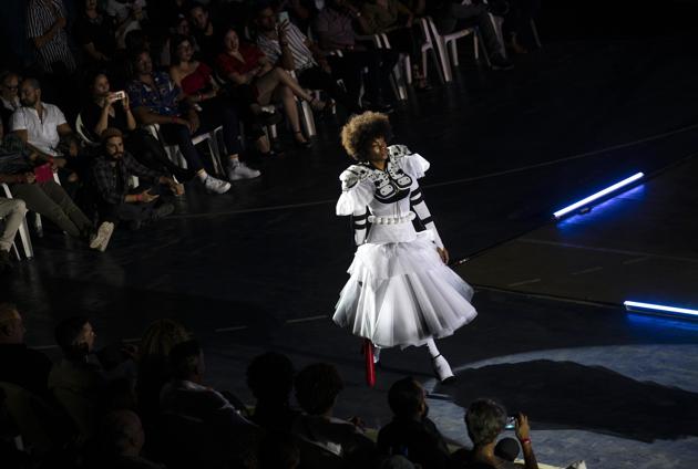 A model wears a creation from "Clandestina," the first Cuban independent urban fashion brand, during a launch for the 2020 collection called Sports Glories in Havana, Cuba, Friday, Nov. 22, 2019. (AP Photo/Ramon Espinosa) (AP) A model wears a creation from "Clandestina," the first Cuban independent urban fashion brand, during a launch for the 2020 collection called Sports Glories in Havana, Cuba, Friday, Nov. 22, 2019. (AP Photo/Ramon Espinosa) (AP)