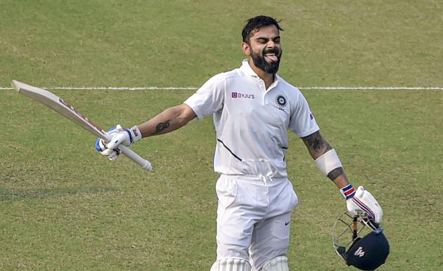 Indian Skipper Virat Kohli acknowledges the crowd after scoring a century. (PTI)