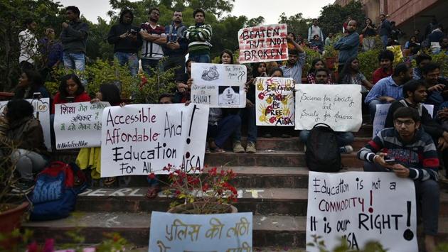 Jawaharlal Nehru University (JNU) students hold placards while protesting against the hostel fee hike and other issues at the admin block of JNU campus in New Delhi. (Biplov Bhuyan / HT Photo)