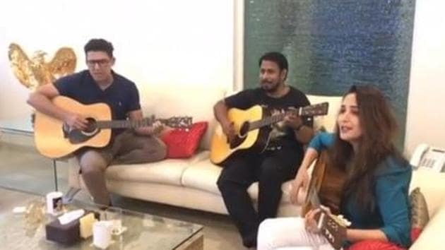 Madhuri Dixit sings and plays guitar at a family gathering.