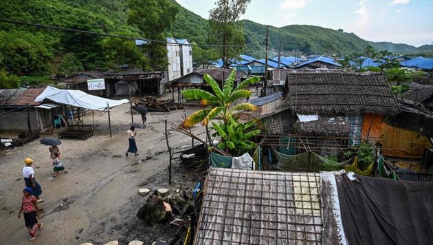 People walk in Kyauktalone camp in Kyaukphyu, Rakhine state, where Muslim residents have been forced to live for seven years after the inter-communal unrest tore apart the town. Some 130,000 Muslims, the vast majority Rohingya, have been languishing in various camps in central Rakhine since the violence between Buddhist and Muslims swept through the region in 2012, without decent access to education, healthcare and work. (Ye Aung Thu / AFP)