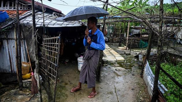A man stands outside a house in Kyauktalone camp in Kyaukphyu. Before the attacks, some were teachers, lawyers and judges, while others fished or drove ox carts transporting cargo and people between the shore and the wooden boats that moor off the working beach. Those jobs in the town are now exclusively carried out by ethnic Rakhine Buddhists, who have also taken over any still-intact homes of Muslims. (Ye Aung Thu / AFP)