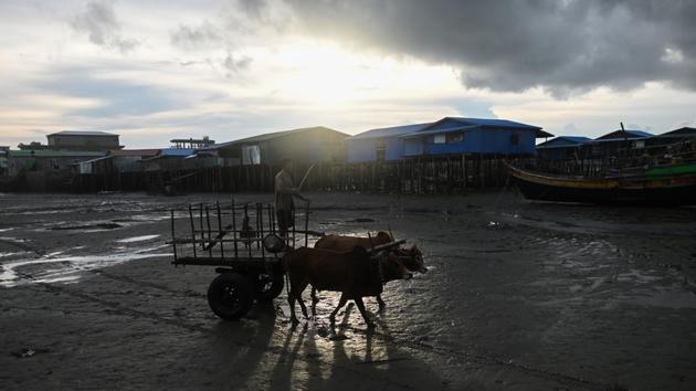 A man rides an ox cart on the beach in Kyaukphyu. Amnesty International brands the “institutionalised system of segregation and discrimination” so severe it constitutes “apartheid”. Muslims continue to lack access to education, healthcare and work -- a situation Amnesty’s Laura Haigh describes as both “unacceptable and criminal”. (Ye Aung Thu / AFP)