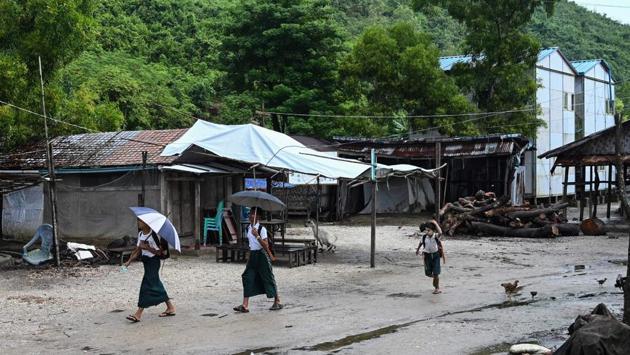 Students walk in Kyauktalone camp in Kyaukphyu. Many have been forced to accept a controversial National Verification Card (NVC), a limbo status offering few rights until holders “prove” their claim to full citizenship. Rights groups condemn the NVC as a discriminatory tool foisted on many Muslims -- particularly Rohingya -- who they say should already be treated as full citizens. (Ye Aung Thu / AFP)