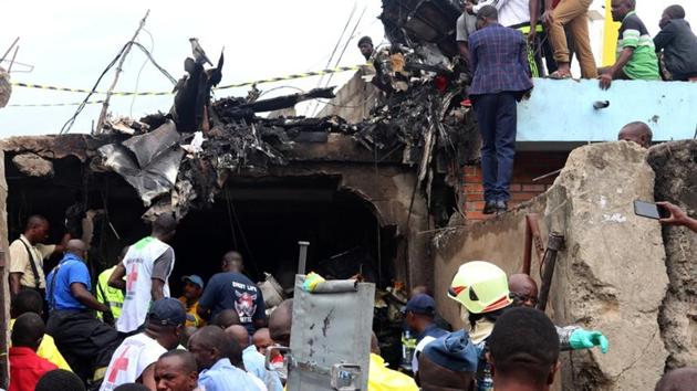 Rescuers and civilians gather at the accident scene of a Dornier 228-200 plane operated by local company Busy Bee that crashed into a densely populated neighborhood in Goma in eastern Democratic Republic of Congo November 24, 2019. (Reuters) Rescuers and civilians gather at the accident scene of a Dornier 228-200 plane operated by local company Busy Bee that crashed into a densely populated neighborhood in Goma in eastern Democratic Republic of Congo November 24, 2019. (Reuters)
