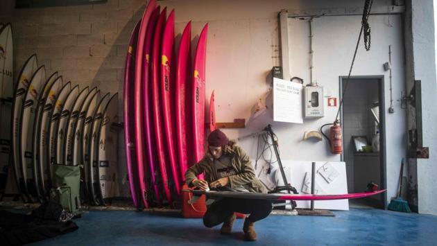 French surfer Justine Dupont waxes her surfboard before a big wave surfing session in Nazare.Earlier this month the news broke that a set of fearsome 20-metre waves were coming to this small town located in the Atlantic coast. The message spread like wildfire and soon extreme surfers and sports fans -- as well as keen photographers -- arrived at the town’s Praia de Norte beach. (Olivier Morin / AFP) French surfer Justine Dupont waxes her surfboard before a big wave surfing session in Nazare.Earlier this month the news broke that a set of fearsome 20-metre waves were coming to this small town located in the Atlantic coast. The message spread like wildfire and soon extreme surfers and sports fans -- as well as keen photographers -- arrived at the town’s Praia de Norte beach. (Olivier Morin / AFP)