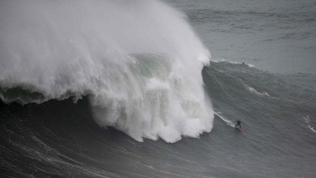 Dupont rides a big wave during a free surfing session in Nazare. She has spent four winters chasing the extreme waves in the town. She said the seaside town with a population of 15,000 has become a surf haven over the last few years. “It’s mad!” she said. “Two years ago we went to see the sea by the lighthouse, there were no cars parked -- now, you can’t drive.” (Olivier Morin / AFP) Dupont rides a big wave during a free surfing session in Nazare. She has spent four winters chasing the extreme waves in the town. She said the seaside town with a population of 15,000 has become a surf haven over the last few years. “It’s mad!” she said. “Two years ago we went to see the sea by the lighthouse, there were no cars parked -- now, you can’t drive.” (Olivier Morin / AFP)