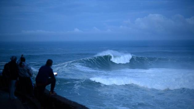 Surfers watch the wave conditions early morning before a free surfing session in Nazare. The monster waves have always crashed at the town’s beach, but surfers had previously ignored Portugal and gravitated towards beaches in California and Hawaii. Anne-Marie Sana-Boisson, who owns a market stall in Nazare, said that the town has changed rapidly over the last four years -- and not necessarily for the better. (Olivier Morin / AFP) Surfers watch the wave conditions early morning before a free surfing session in Nazare. The monster waves have always crashed at the town’s beach, but surfers had previously ignored Portugal and gravitated towards beaches in California and Hawaii. Anne-Marie Sana-Boisson, who owns a market stall in Nazare, said that the town has changed rapidly over the last four years -- and not necessarily for the better. (Olivier Morin / AFP)