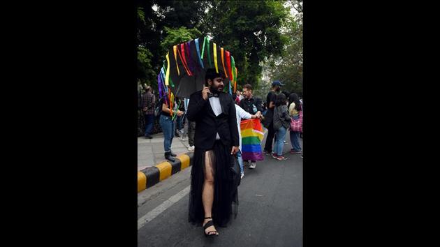 A person wearing a gender-nonconforming attire walks in the pride parade while holding an umbrella with rainbow-coloured ribbons. During a pride march, members of the LGBTQ community get the required safe space to openly challenge and break the heteronormative norms of our society. (Amal KS / HT Photo) A person wearing a gender-nonconforming attire walks in the pride parade while holding an umbrella with rainbow-coloured ribbons. During a pride march, members of the LGBTQ community get the required safe space to openly challenge and break the heteronormative norms of our society. (Amal KS / HT Photo)