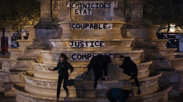 From left to right, Pauline, Clivia, France and Lea paste a slogan on a fountain reading “ Femicides: guilty state, accomplice justice” in Paris. Lawyers and victims’ advocates say women are too often disbelieved or turned away by law enforcement. But they’re encouraged by the new national conversation, which they say marks a departure from decades of denial. “In France, we always have the impression that we are perfect,” feminist activist Caroline de Haas said. (Kamil Zihnioglu / AP) From left to right, Pauline, Clivia, France and Lea paste a slogan on a fountain reading “ Femicides: guilty state, accomplice justice” in Paris. Lawyers and victims’ advocates say women are too often disbelieved or turned away by law enforcement. But they’re encouraged by the new national conversation, which they say marks a departure from decades of denial. “In France, we always have the impression that we are perfect,” feminist activist Caroline de Haas said. (Kamil Zihnioglu / AP)