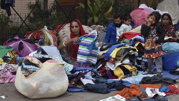 A woman from the community folds clothes and bundles them. The clothes are sorted based on different categories—shirts, trousers, jeans, sweaters, etc. The women who travel long distances to barter are known as ‘bartanwalis’ (women who sell utensils). The traders who buy the used clothes from the women, further sell them to millions of people in villages and small towns across the country, who cannot afford new garments. (Sanjeev Verma / HT Photo) A woman from the community folds clothes and bundles them. The clothes are sorted based on different categories—shirts, trousers, jeans, sweaters, etc. The women who travel long distances to barter are known as ‘bartanwalis’ (women who sell utensils). The traders who buy the used clothes from the women, further sell them to millions of people in villages and small towns across the country, who cannot afford new garments. (Sanjeev Verma / HT Photo)