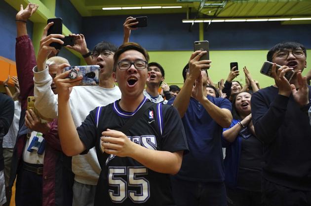 Supporters of pro-democracy candidate Angus Wong celebrate after he won in district council elections in Hong Kong, early Monday, Nov. 25, 2019. Vote counting was underway in Hong Kong early Monday after a massive turnout in district council elections seen as a barometer of public support for pro-democracy protests that have rocked the semi-autonomous Chinese territory for more than five months. (AP) Supporters of pro-democracy candidate Angus Wong celebrate after he won in district council elections in Hong Kong, early Monday, Nov. 25, 2019. Vote counting was underway in Hong Kong early Monday after a massive turnout in district council elections seen as a barometer of public support for pro-democracy protests that have rocked the semi-autonomous Chinese territory for more than five months. (AP)