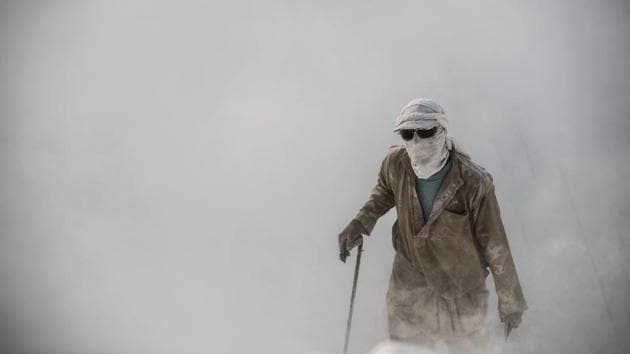 A labourer walks wearing protective gear at the ‘White Mountain’ limestone extraction quarry site near Egypt’s southern city of Minya. Covered in fine white dust, labourers at this limestone quarry toil in brutal conditions with little workplace safety for paltry pay. (Khaled Desouki / AFP)