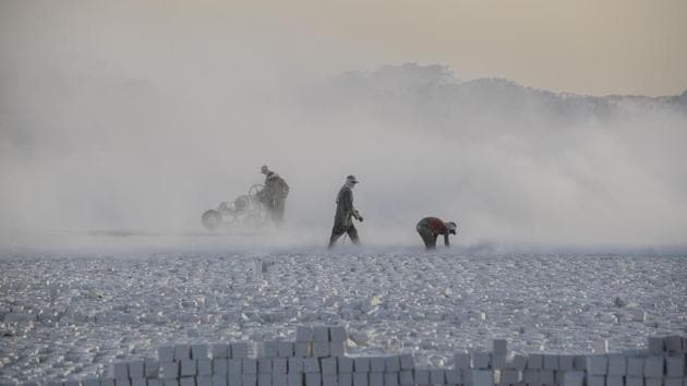 Huge electric saws on rails slice rows of blocks from the mountainside. Workers then stack the stone in long, neat rows. The white bricks are destined to be used in construction, or ground down for use in ceramics. (Khaled Desouki / AFP)