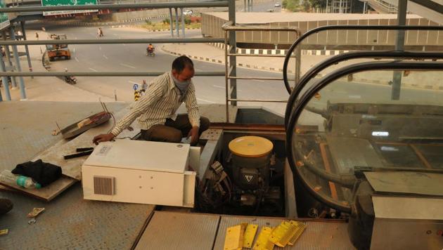 A damaged escalator at Signature Tower Chowk, in Gurugram, being repaired, Monday, November 25, 2019.