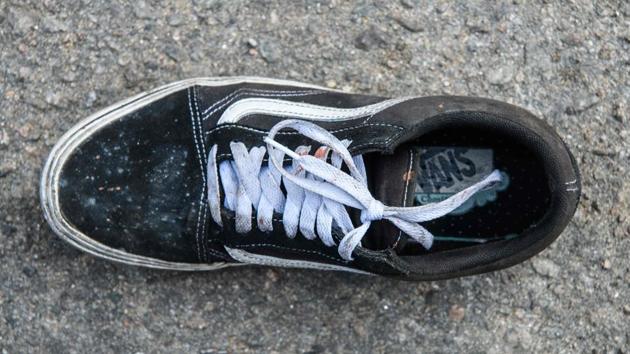 A shoe with blood on the laces is seen on a road outside the main entrance of the campus. A tense pause has since set in, with scattered holdouts still believed to be inside as officers refrain from storming the campus. (Anthony Wallace / AFP) A shoe with blood on the laces is seen on a road outside the main entrance of the campus. A tense pause has since set in, with scattered holdouts still believed to be inside as officers refrain from storming the campus. (Anthony Wallace / AFP)