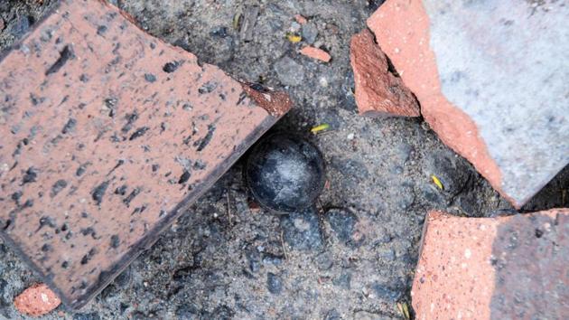A rubber bullet fired by police is seen on a road outside the main entrance of the campus. The savagery during the clashes is written in the debris left behind on the normally tidy campus, just a stone’s throw from Hong Kong’s picturesque harbour. (Anthony Wallace / AFP) A rubber bullet fired by police is seen on a road outside the main entrance of the campus. The savagery during the clashes is written in the debris left behind on the normally tidy campus, just a stone’s throw from Hong Kong’s picturesque harbour. (Anthony Wallace / AFP)