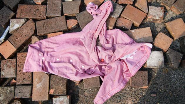 An item of clothing is seen on a road outside the main entrance of the campus. Left on the campus is police weaponry mixed with the sometimes crude means used by protesters to both protect themselves and fight back. (Anthony Wallace / AFP) An item of clothing is seen on a road outside the main entrance of the campus. Left on the campus is police weaponry mixed with the sometimes crude means used by protesters to both protect themselves and fight back. (Anthony Wallace / AFP)