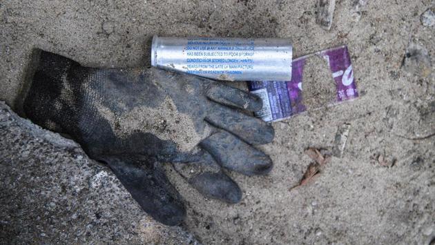 A spent tear gas shell fired by police and a glove -- usually used to pick up tear gas rounds to be thrown back to authorities -- are seen on a road outside the main entrance of the Hong Kong Polytechnic University campus. Spent tear gas shells are widely scattered in the campus, as are bean bag rounds, rubber bullets, and sponge grenades. (Anthony Wallace / AFP) A spent tear gas shell fired by police and a glove -- usually used to pick up tear gas rounds to be thrown back to authorities -- are seen on a road outside the main entrance of the Hong Kong Polytechnic University campus. Spent tear gas shells are widely scattered in the campus, as are bean bag rounds, rubber bullets, and sponge grenades. (Anthony Wallace / AFP)