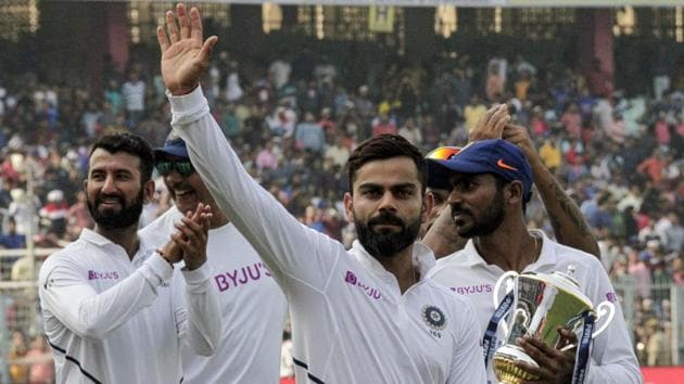 India's captain Virat Kohli gestures to spectators as he leads his team in a victory lap after winning the second match and test series against Bangladesh in Kolkata.(AP)
