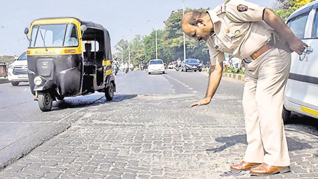 Police official explaining the road flaws which lead to the accident in front of Katraj snake park(Sanket Wankhade/HT PHOTO)