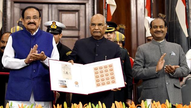 New Delhi, Nov 26 (ANI): President Ram Nath Kovind, Vice President M Venkaiah Naidu, and Lok Sabha speaker Om Birla releasing the commemoration postal stamp of the 250th session of Rajya Sabha during the joint sitting of parliament on the occasion of 70th Constitution Day celebrations, in New Delhi on Tuesday. (ANI Photo/ R Raveendran)