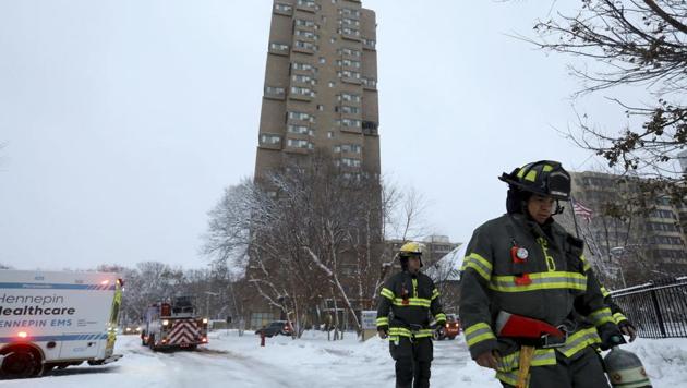 Minneapolis firefighters leave after a deadly fire at a high-rise apartment building, in background(AP) Minneapolis firefighters leave after a deadly fire at a high-rise apartment building, in background(AP)