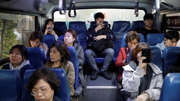 Hwang Hyeon-dong looks at his mobile phone as he makes his way home on a bus. Older workers are also feeling the pinch as Moon tries to improve employment opportunities and social justice for young workers. In a televised town hall meeting last week, Moon conceded he had fallen short on those promises and said his declining support among youth was proof he had let them down. (Kim Hong-Ji / REUTERS)
