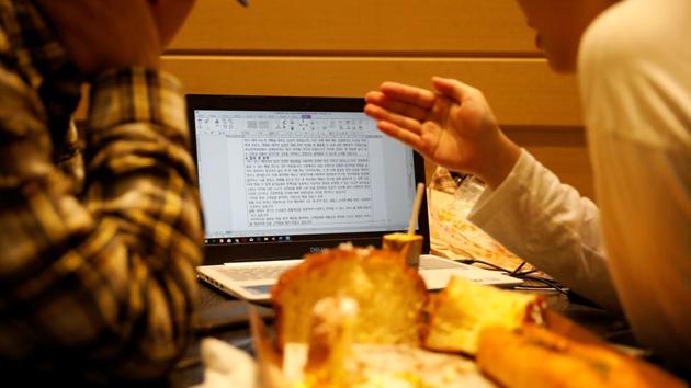Hwang checks his girlfriend’s resume in a cafe. Income disparity has instead widened since Moon took office, the top income bracket now earning 5.5 times the bottom one, compared with 4.9 times before his inauguration, official data shows. Hwang, a media studies student, said a corruption scandal surrounding former Justice Minister Cho Kuk was a wakeup call for dirt spoons who may have once believed in the hard work. (Kim Hong-Ji / REUTERS)