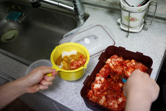 Kim works as a part-time waiter at a bar near his school and gets by on 400,000 won a month for rent, food and allowances. Most meals are “cup rice” he prepares in the shared kitchen, menial fare of rice and basic toppings - eggs, half an onion and sauce. Young, low-income voters like Kim have deserted Moon in record numbers. (Kim Hong-Ji / REUTERS)